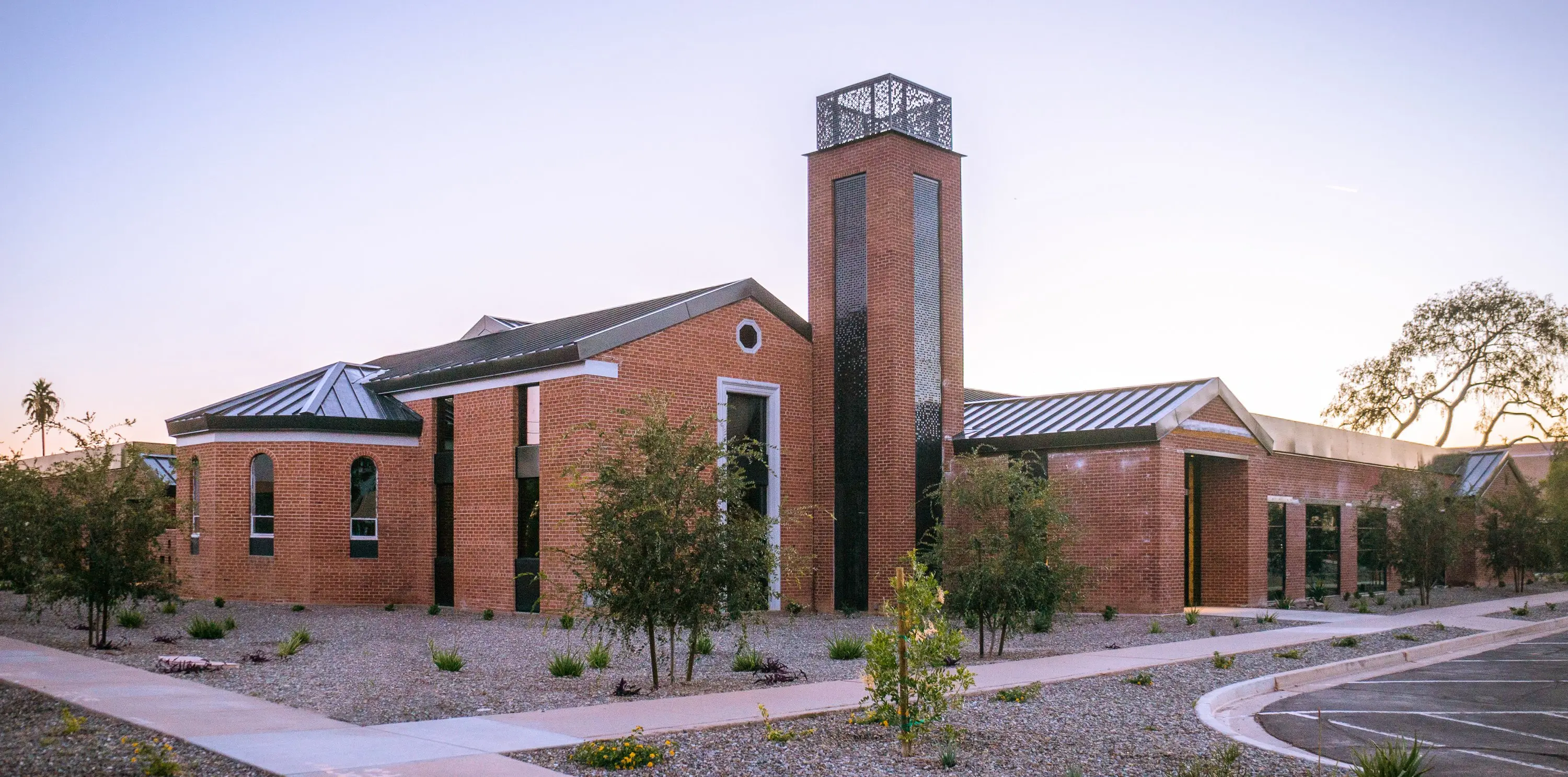 Meetinghouse 3080, a brick adaptive reuse building with a bell tower in Old Town Scottsdale, at dusk