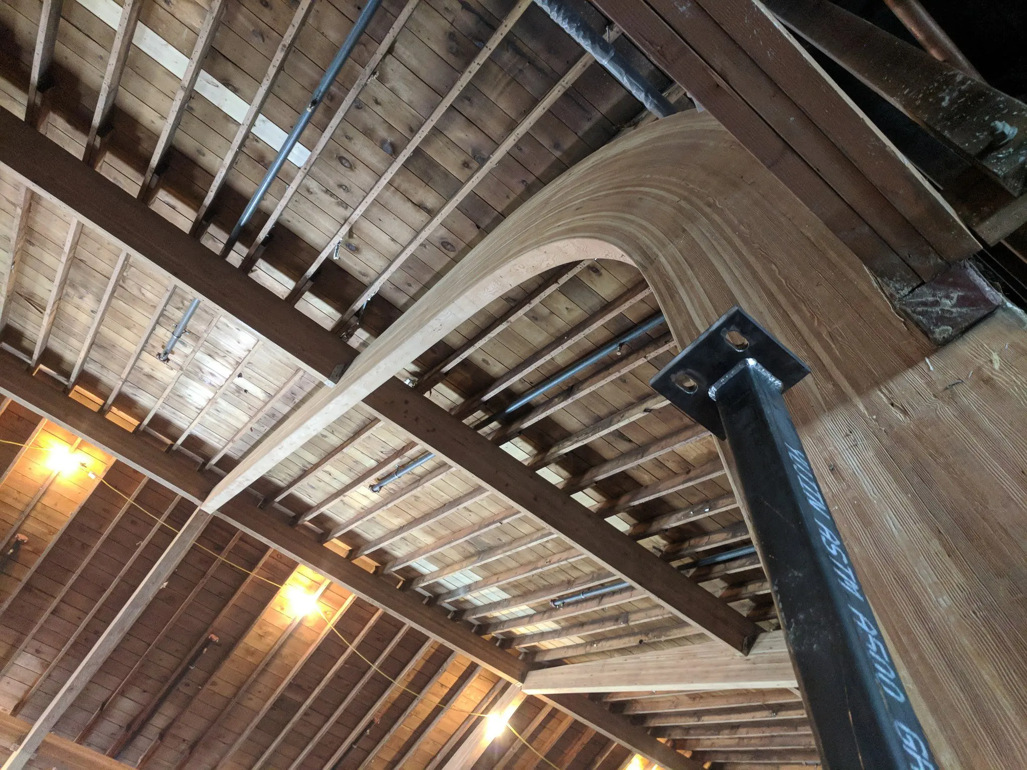 Laminated timber beams and steel connections in a renovated roof structure