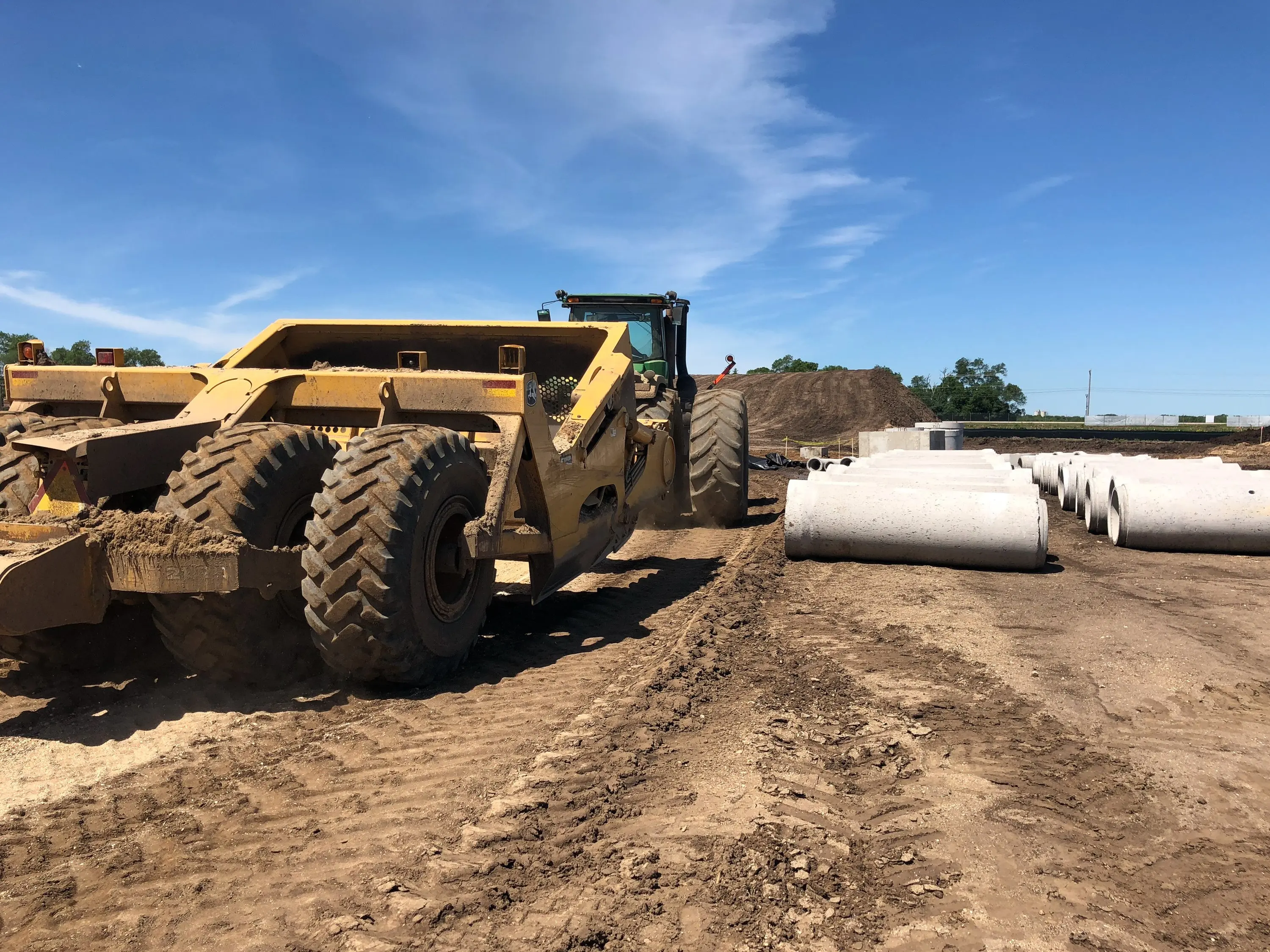 Earthmoving equipment grading a construction site at Camping World Roscoe